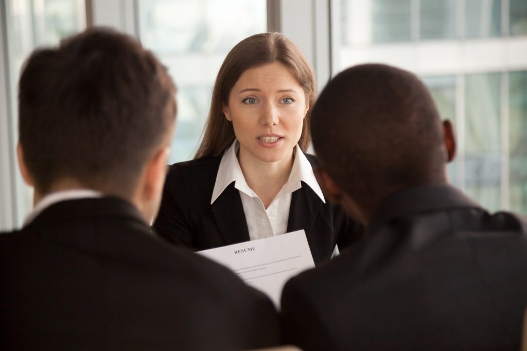 Female applicant introducing herself during job interview, talki